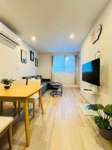 a living room with a couch and a table at Year-end promotion 2 Gread location 1min to Station Closs Ueno Max 6 people Wi-fi unlimited in Tokyo