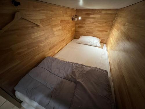 a small bed in the middle of a small room at Your Place Inn in Karon Beach