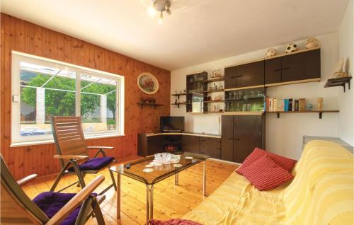 a living room with a couch and a table at Two-Bedroom Apartment In Racisce in Račišće