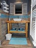 a small bathroom with a sink and a counter at Les Keriaden's in Pleudihen