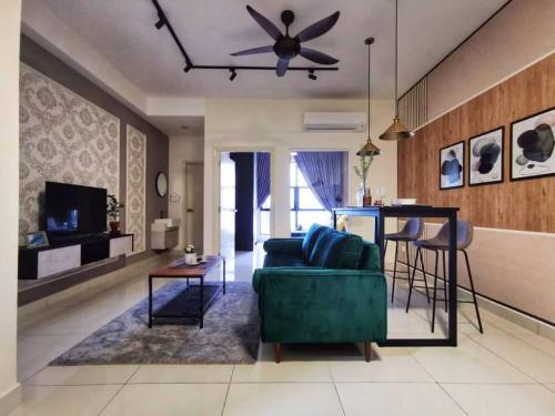 a living room with a green couch and a table at Arte Mont Kiara Studio,Kuala Lumpur in Kuala Lumpur