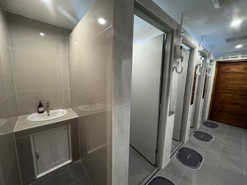 a bathroom with a sink and a shower at Your Place Inn in Karon Beach