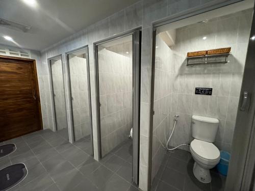 a bathroom with a toilet and a walk in shower at Your Place Inn in Karon Beach