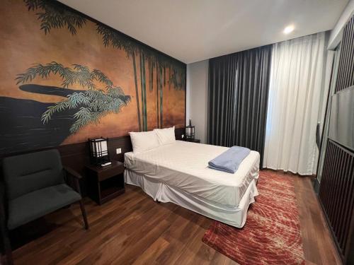 a bedroom with a bed and a painting on the wall at Lotus Wyndham Thanh Thủy in Phú Thọ