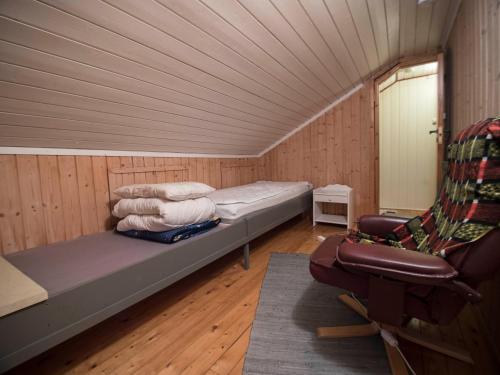 a small room with a bed and a chair at Hansali Holiday Home in Fjarland