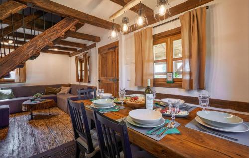 a dining room with a wooden table and a couch at Gorgeous Home In Popovaca With Wifi in Popovača