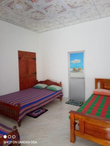 a bedroom with two beds in a room at Wasana Guest Yala in Kirinda