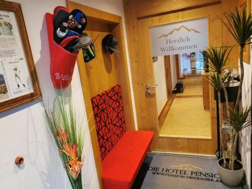 a hallway with a red bench in front of a door at No1 - Flo's Rooms & Breakfast in Wagrain