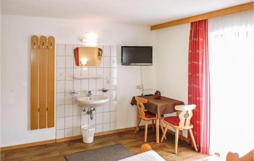 a small bathroom with a sink and a table with a sink at Charmante Ferienwohnung Kappl in Kappl