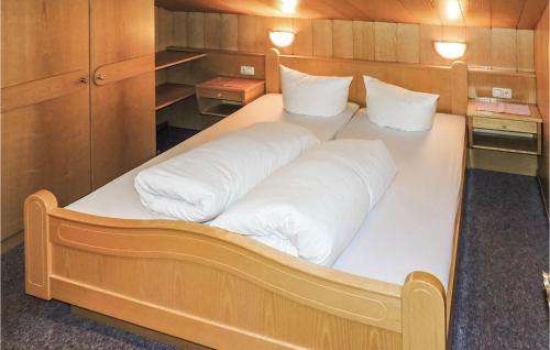 a large white bed in a small room at Charmante Ferienwohnung Kappl in Kappl