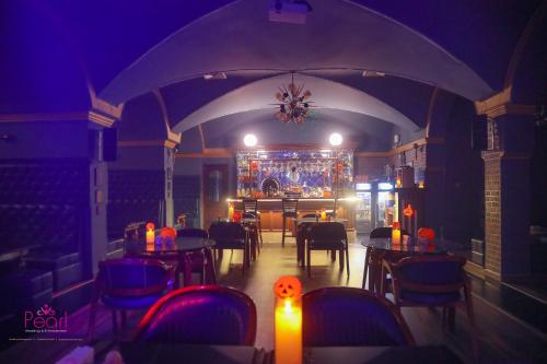 a room with tables and chairs in a restaurant at Goa Country Club Near Park Hospital BY Pearl I Luxury resort in Gurgaon in Gurgaon