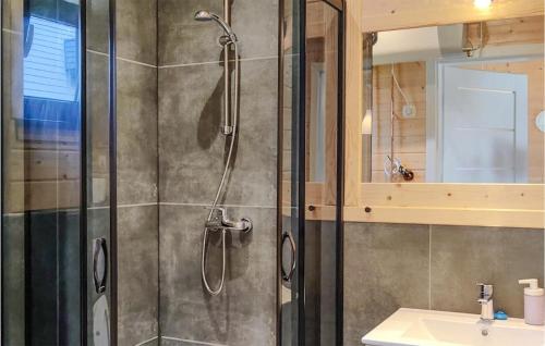 a shower with a glass door in a bathroom at Awesome Home In Jantar With Sauna in Jantar