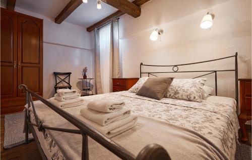 a bedroom with a bed with towels on it at Gorgeous Home In Popovaca With Wifi in Popovača