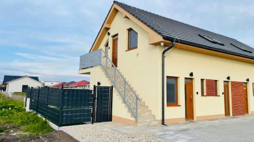a house with a staircase in front of it at HENRY APARTMENT - Nesvady - Slovakia in Nesvady