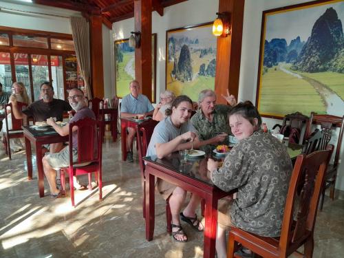 a group of people sitting at tables in a restaurant at Lys Homestay in Ninh Binh