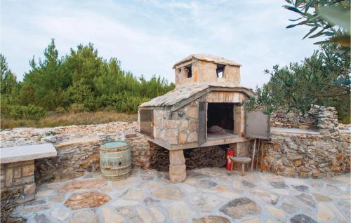 an outdoor pizza oven sitting on a stone patio at Holiday Home Jezera With A Fireplace 04 in Jezera