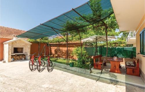 two bikes parked under a canopy in a patio at Holiday Home Kresevo 23 in Kreševo