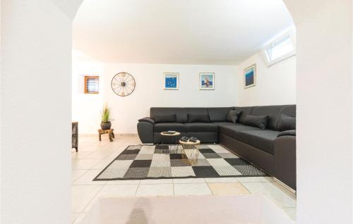 a living room with a black couch and a table at Two-Bedroom Holiday Home In Trilj in Trilj