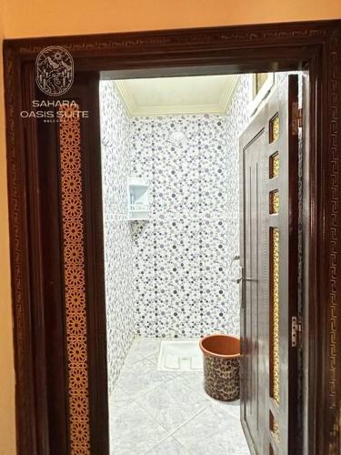 a door leading to a bathroom with a toilet at appartement meublé servitio 2 in Laayoune