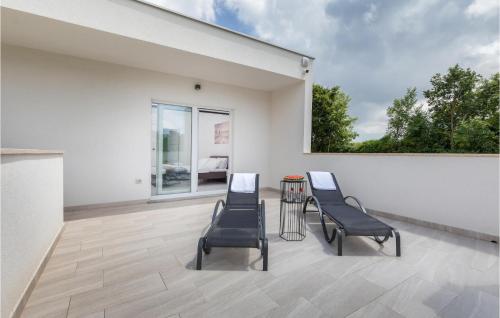 two chairs and a table on a patio at 4 Bedroom Beautiful Home In Jursici in Juršići