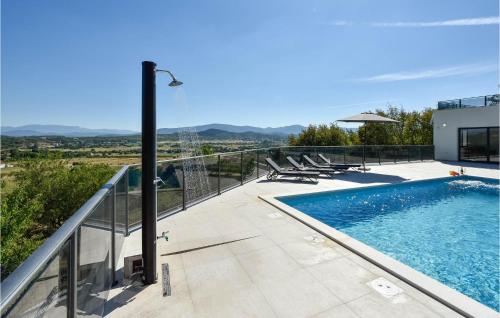 a swimming pool on the balcony of a house at Stunning Home In Obrovac Sinjski in Obrovac Sinjski