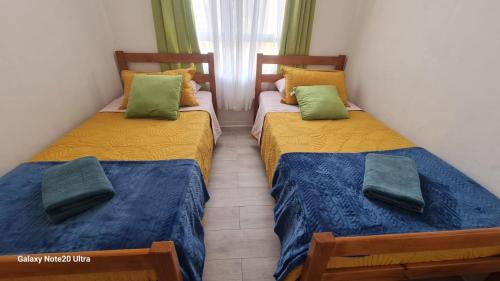 Ένα ή περισσότερα κρεβάτια σε δωμάτιο στο departamento 6 Arica verano 2 habitaciones