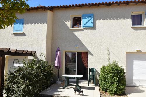 a dog is looking out of the window of a house at location maison à Cajarc 46160 (Lot) in Cajarc