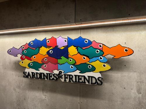 a sign with a bunch of fish on a wall at Sardines and Friends Hostel 06 in Póvoa de Varzim
