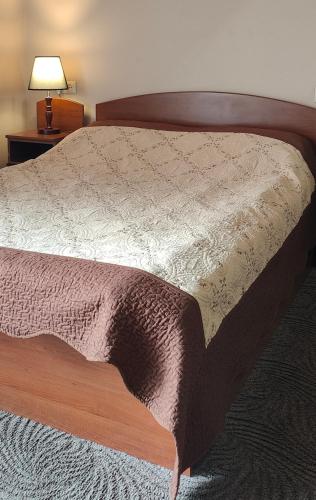 a bedroom with a bed with a wooden head board at Areg Hotel in Yerevan