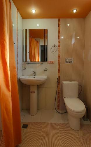a bathroom with a toilet and a sink at Areg Hotel in Yerevan