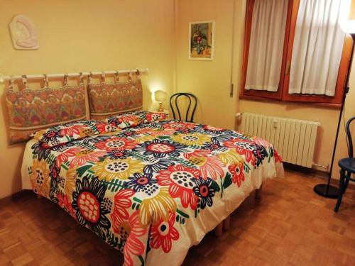 a bedroom with a large bed with a colorful comforter at Casa Ena in Roccaraso
