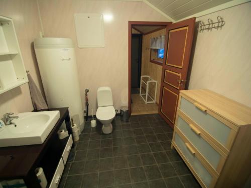 a small bathroom with a toilet and a sink at Hansali Holiday Home in Fjarland