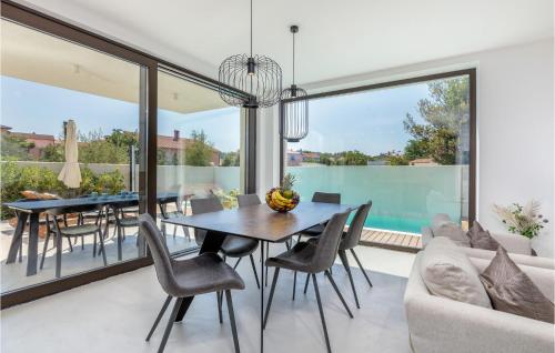 a dining room with a table and chairs at 3 Bedroom Gorgeous Home In Pula in Pula