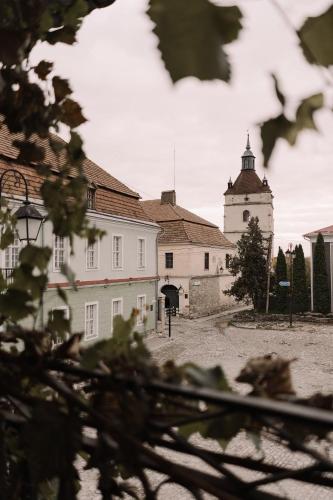 a large white building with a clock tower at n o c t u r n e in Kamianets-Podilskyi