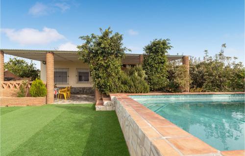 a backyard with a swimming pool and a house at Lovely Home In Almayate With Wi-Fi in Almayate Alto