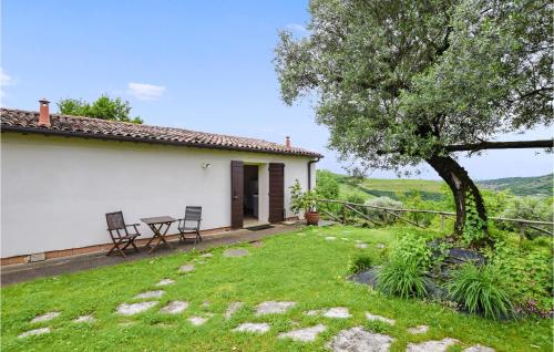 a house with a table and chairs in a yard at 2 Bedroom Gorgeous Home In Vò Euganeo in Boccon