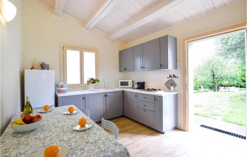 a kitchen with a table with oranges on it at 2 Bedroom Gorgeous Home In Vò Euganeo in Boccon