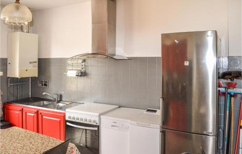 a kitchen with a stainless steel refrigerator at Cozy Home In Coutras With Kitchen in Coutras