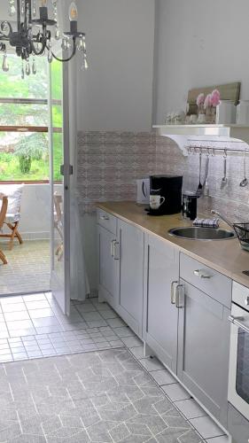 a kitchen with white cabinets and a counter top at Nostalgie-Loft in Mayen