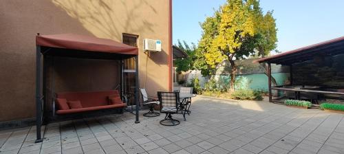 a patio with a couch and an awning on a house at Areg Hotel in Yerevan