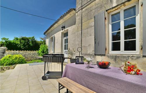 a table with a bowl of fruit on top of it at Awesome Home In Arthenac With Wifi in Arthenac