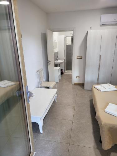 a hospital room with two beds and a sink at Le Ghie in Mondovì