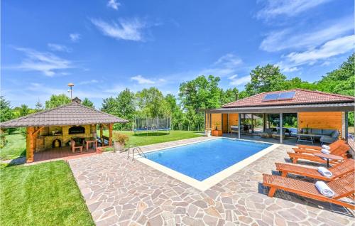 a backyard with a swimming pool and a gazebo at Beautiful Home In Kelemen With Sauna in Kelemen