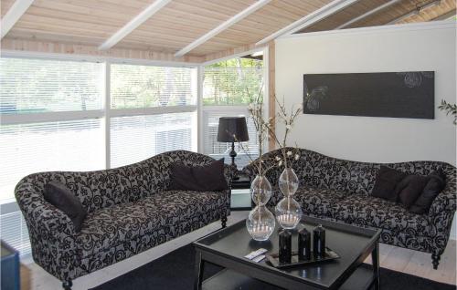 a living room with two couches and a table at Holiday Home Hægvej Grenaa V in Grenå