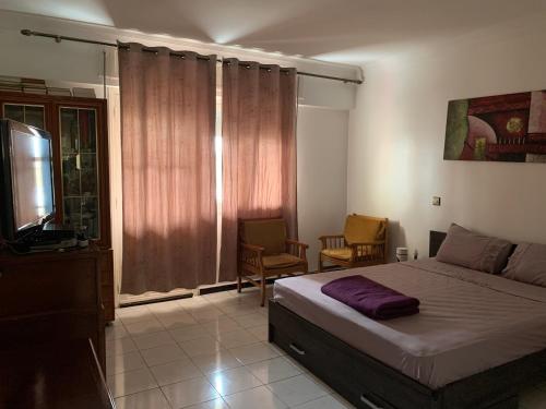 Ένα ή περισσότερα κρεβάτια σε δωμάτιο στο Appartement familial