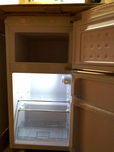 an empty refrigerator with its door open in a kitchen at Lydia Enoch Sweet Family in Renton