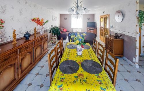 a dining room with a yellow table and chairs at Lovely Home In Quoux-Haut-Maînil in Haut-Maînil