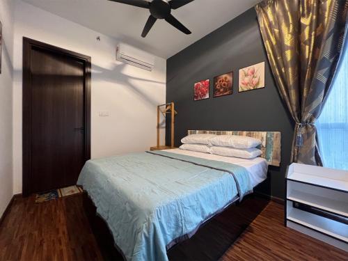 a bedroom with a bed and a ceiling fan at K AVENUE - 2 Bedroom with Privacy Balcony by Akinabalu Family Homestay in Donggongon