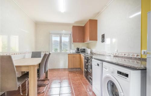a kitchen with a table and a washing machine at Amazing Home In Candamo With Kitchen in Candamo