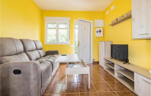a living room with a couch and a tv at Amazing Home In Candamo With Kitchen in Candamo